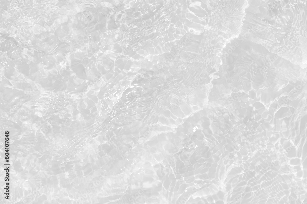 Naklejka premium White water with ripples on the surface. Defocus blurred transparent white colored clear calm water surface texture with splashes and bubbles. Water waves with shining pattern texture background.