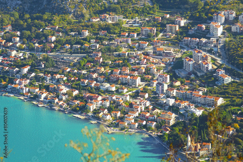 Real estate on the sea coast: aerial view of the development in Dobrota, a suburb of the city of Kotor. Houses in Montenegro. © tanyatorgonskaya