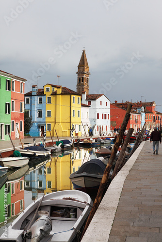 Burano island, typical street canal and multi-colored houses of locals.