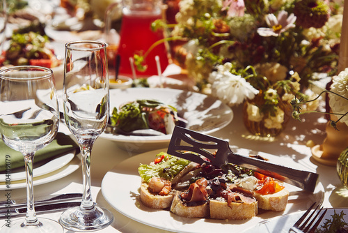 Table setting within the elegant chamber mood, under captivating shadows. The wedding style channels Provence's aesthetics