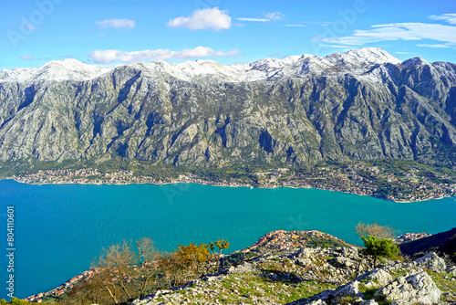 Bay of Kotor in Montenegro from Mount Vrmac: breathtaking views from the top of high snow-capped mountains, small settlements on the coast and the bright blue waters of the Adriatic Sea.