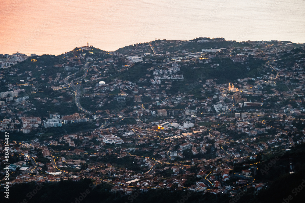 beautiful sunset over the city of Funchal on Madeira from the location Miradouro do Pico Alto. Mountains landscape