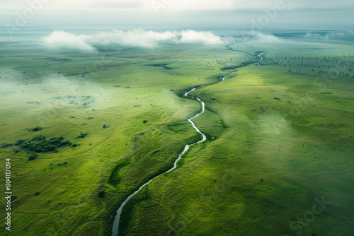 Aerial view of an endless grassland with a distant river