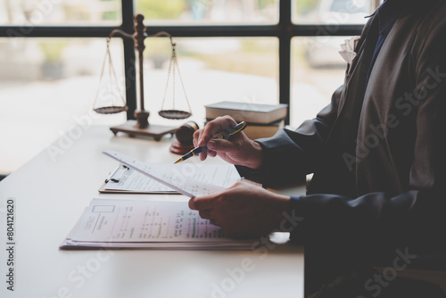 A lawyer or legal advisor is reading business evidence. Legal matters and carefully check the correctness of investment agreement documents to sign management contracts, fairness concept.