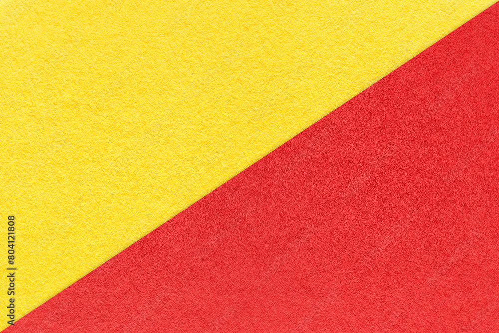 Texture of craft red and yellow paper background, half two colors, macro. Vintage kraft cardboard Texture of craft red and yellow paper background, half two colors, macro. Vintage kraft cardboard