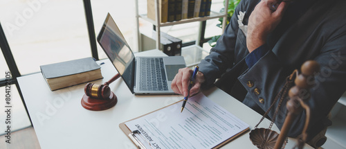 A lawyer or legal advisor is reading business evidence. Legal matters and carefully check the correctness of investment agreement documents to sign management contracts, fairness concept. photo