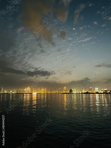 city river at the night time, illumination reflection on the water surface © Oksana