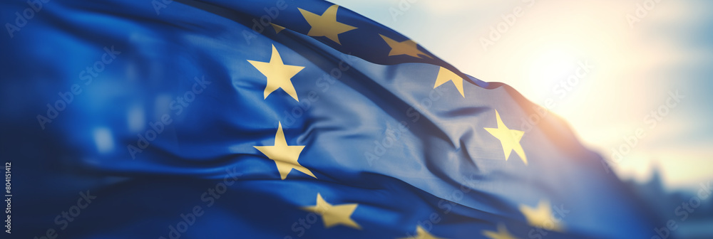 Flag of European Union waving in the breeze against a sunset sky. Banner with EU flag. Flag of European Union waving in the breeze against a sunset sky. Banner with EU flag.