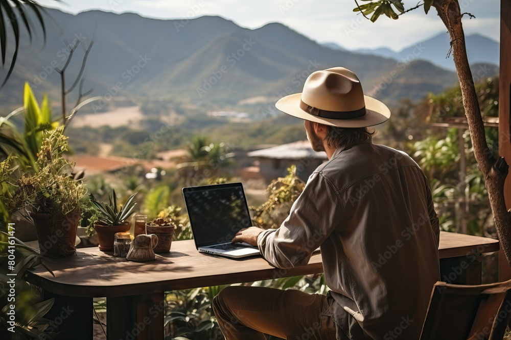 Male tourist works remotely from work, rest in the mountains and remote work with a laptop. Male tourist works remotely from work, rest in the mountains and remote work with a laptop.