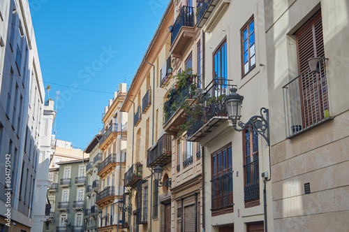 Traditional Spanish street with European balconies and blue sky Spain