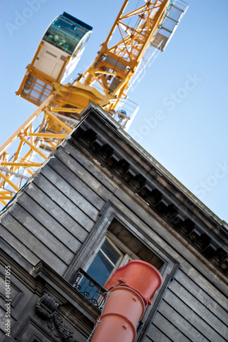 Crane and industrial equipment on a house facade