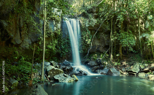 Waterfall in forest with water hitting rocks 