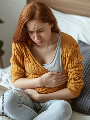 A young lady experiencing stomach discomfort, representing menstrual cramps or digestive issues.