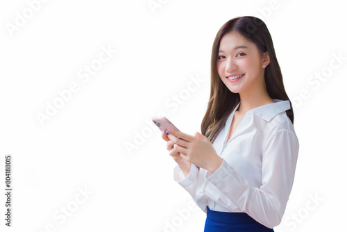 Young asian beautiful business female stands on flyover of skytrain in town while uses her smartphone to send messages to customers while isolated white background.