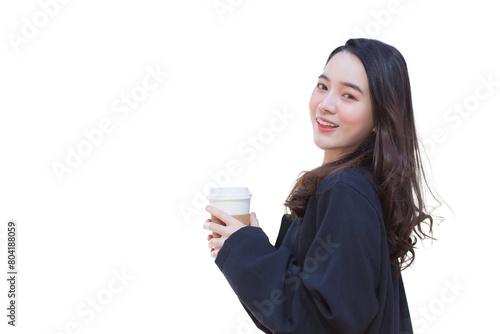 A beautiful young Asian woman in a dark blue suit smiles confidently while holding a coffee mug in her hand on her way to work at the office while isolated white background.