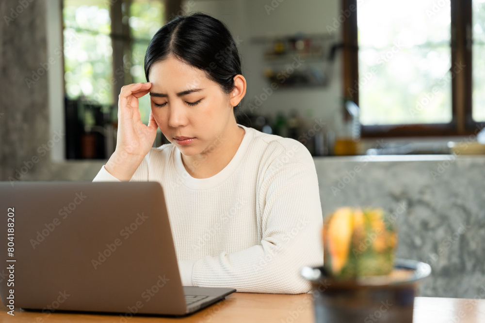 Young asian business woman hand touching head she's feeling depressed stress headache be tired from working with laptop a long time she symptom office syndrome. Young asian business woman hand touching head she's feeling depressed stress headache be tired from working with laptop a long time she symptom office syndrome.