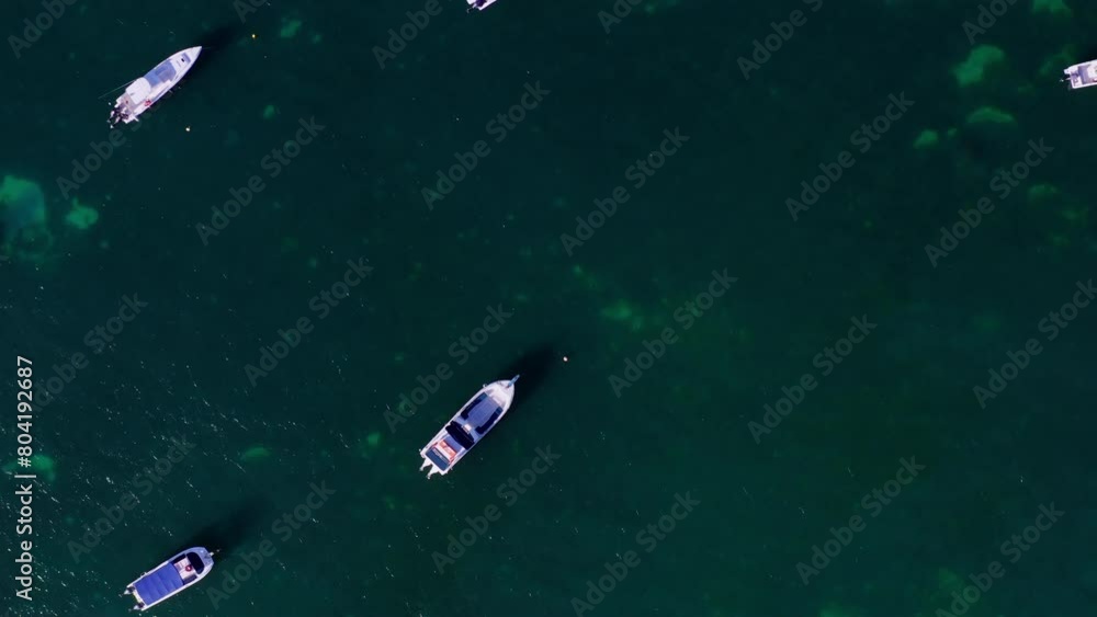 Topdown aerial view of a boat parking area in the ocean. Speedboats moored in the Indian ocean. Seychelles. Crystal-clear, transparent, turquoise waters. motorboat, speedboat, fishing boat, seascape Topdown aerial view of a boat parking area in the ocean. Speedboats moored in the Indian ocean. Seychelles. Crystal-clear, transparent, turquoise waters. motorboat, speedboat, fishing boat, seascape