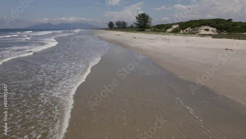 Deserted beach waves, ilha comprida, são paulo, brazil, aerial drone push in parallel photo