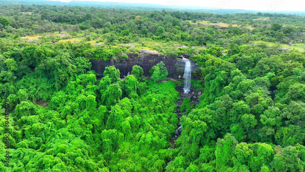 Pha Luang Waterfall is a cascade of water that tumbles down a series of rocky tiers amidst a pristine forested setting. The lush greenery surrounding the waterfall adds to its captivating beauty.
