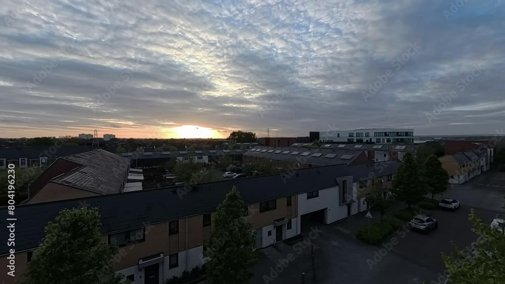 Sunset clouds time lapse passing over Enfield lock housing apartments in London city suburbs Sunset clouds time lapse passing over Enfield lock housing apartments in London city suburbs