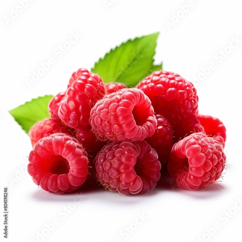 A pile of red raspberries with green leaves on a white background