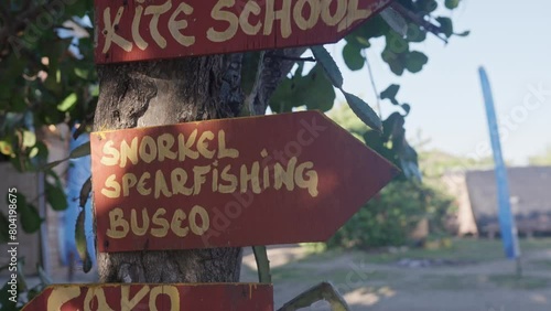 Establishing shot of Kite school and water adventure activity wooden signs photo