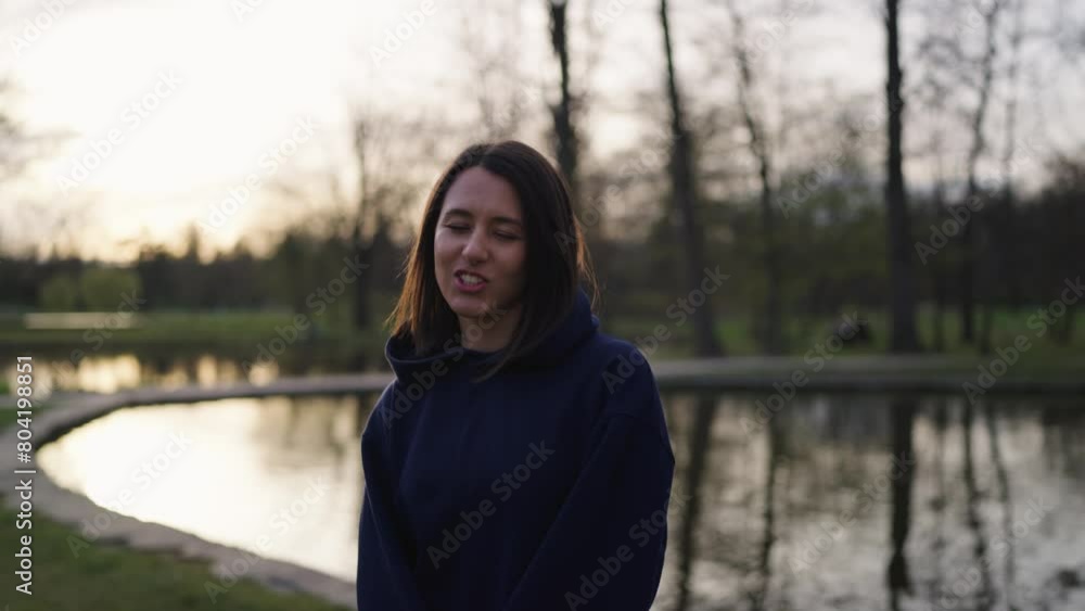 Happy female stand near bright evening pond with tree reflection, Czechia Happy female stand near bright evening pond with tree reflection, Czechia