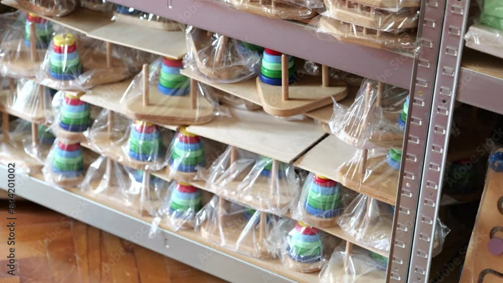 Rows of packaged wooden games and puzzles stored on shelf in game factory. Rows of packaged wooden games and puzzles stored on shelf in game factory.