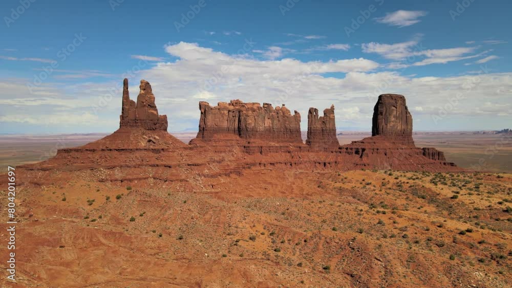 A large rock formation stands prominently in the middle of the barren desert landscape of Monument Valley, located near Mexican Hat, UT on the Arizona-Utah border. A large rock formation stands prominently in the middle of the barren desert landscape of Monument Valley, located near Mexican Hat, UT on the Arizona-Utah border.