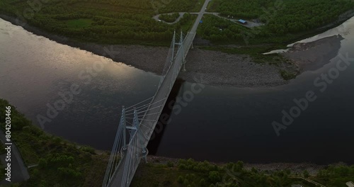 Aerial view backwards over the Sami Bridge and river, sunset in Utsjoki, Finland photo