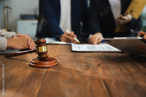 Business people and lawyers discussing contract papers sitting in the table at office in the morning. concepts of law, advice, legal services.