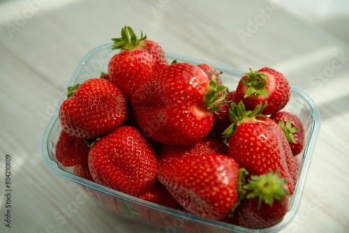 ripe and large strawberries in a box