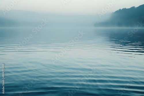 The smooth surface of a lake at dawn, undisturbed
