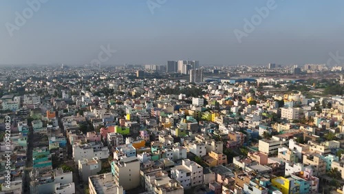 An enchanting aerial view of Chennai's cityscape, with clouds drifting lazily over the architectural wonders and bustling streets below. photo
