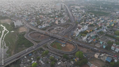 A cinematic drone shot of Chennai, highlighting the city's bustling activity and architectural grandeur under a cloudy sky. photo