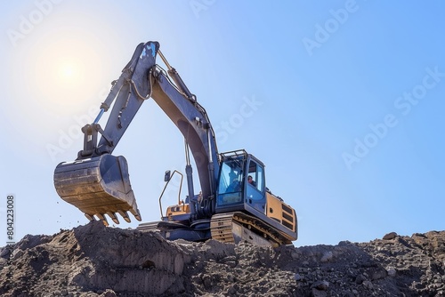 A bulldozer actively excavating a mound of earth at a construction site with powerful machinery in motion