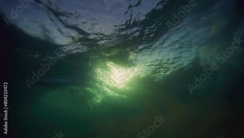 Wallpaper Mural Strong ocean waves break as surfers cross paths, view from underwater Torontodigital.ca