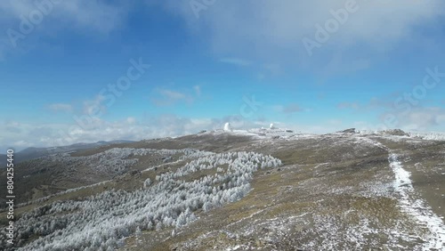 Vista aérea de montañas nevadas y cúpulas de observatorio del calar alto. photo