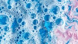 Abstract blue pink soap bubbles on a textured background.