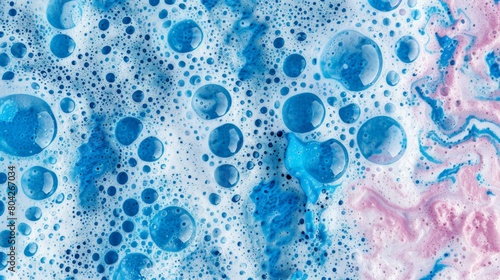 Abstract blue pink soap bubbles on a textured background.