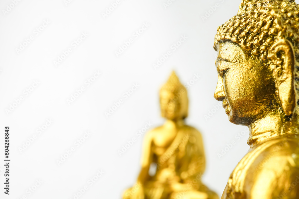 A golden statue of a Buddhist figure meditating facing the side isolated on white background. Bodhisattva Face. Concept for Vesak Day and Enlightenment Day A golden statue of a Buddhist figure meditating facing the side isolated on white background. Bodhisattva Face. Concept for Vesak Day and Enlightenment Day