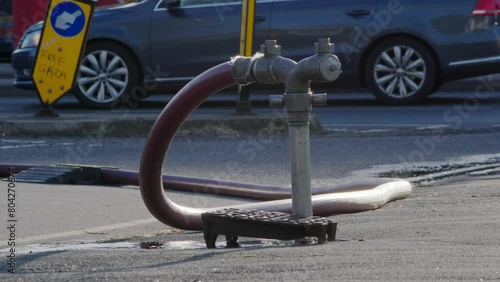 A well in a street has been opened and a fire hydrant connection point to supply water on road in england uk. photo