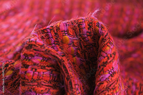 Obraz na plátně Close-up of texture of draped red tweed woven fabric textile background, Chanel style classic fabric