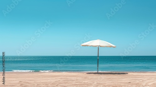 A vibrant beach umbrella provides shade on the sandy shore overlooking the sparkling ocean, with people enjoying the coastal natural landscape under a clear sky AIG50