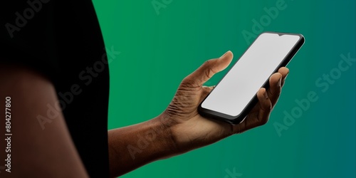 African-American hand with smartphone against green; great for app showcases