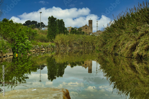 Tranquil River Scene at Sant Boi de Llobregat with Historical Castle in Background photo