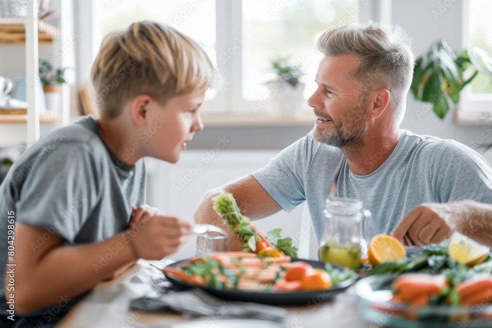 Father having food with son at dining table in house Father having food with son at dining table in house