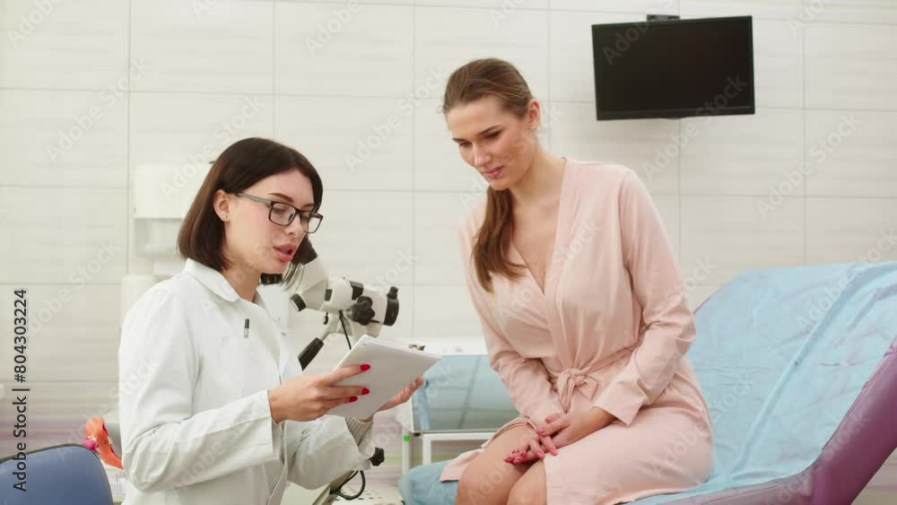 Gynecological office in a modern clinic. The gynecologist uses a colposcope and takes tests from the patient. A woman lies on a gynecological chair during a colposcopy. Preparing for pregnancy. Gynecological office in a modern clinic. The gynecologist uses a colposcope and takes tests from the patient. A woman lies on a gynecological chair during a colposcopy. Preparing for pregnancy.
