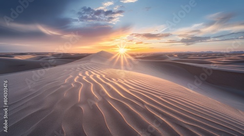Sunset casting golden rays over rippling sand dunes  evoking a sense of peace and the vastness of the desert. Concept of natural beauty  solitude  and expansive landscapes. 