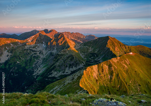 Otrhance mountain ridge near Jakubina peak in Western Tatras mountains in Slovakia with other peaks scenery, hiking trail, relaxing people on stone and blue sky with clouds. Hiking theme.  photo
